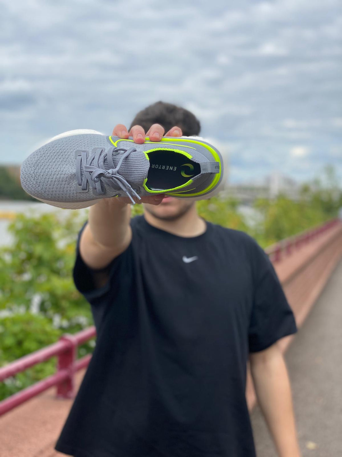 Enertor Insoles in a running shoe with a man wearing a black nike t-shirt in Battersea park