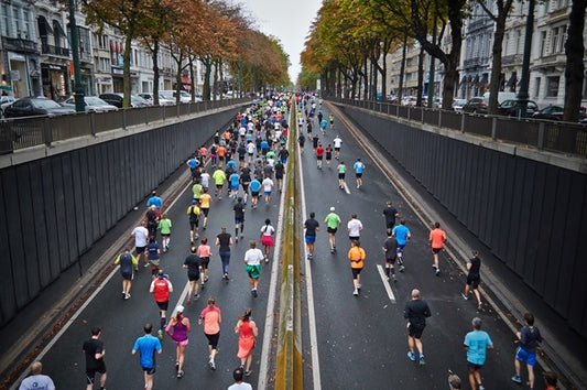 crowd of people running marathon in city
